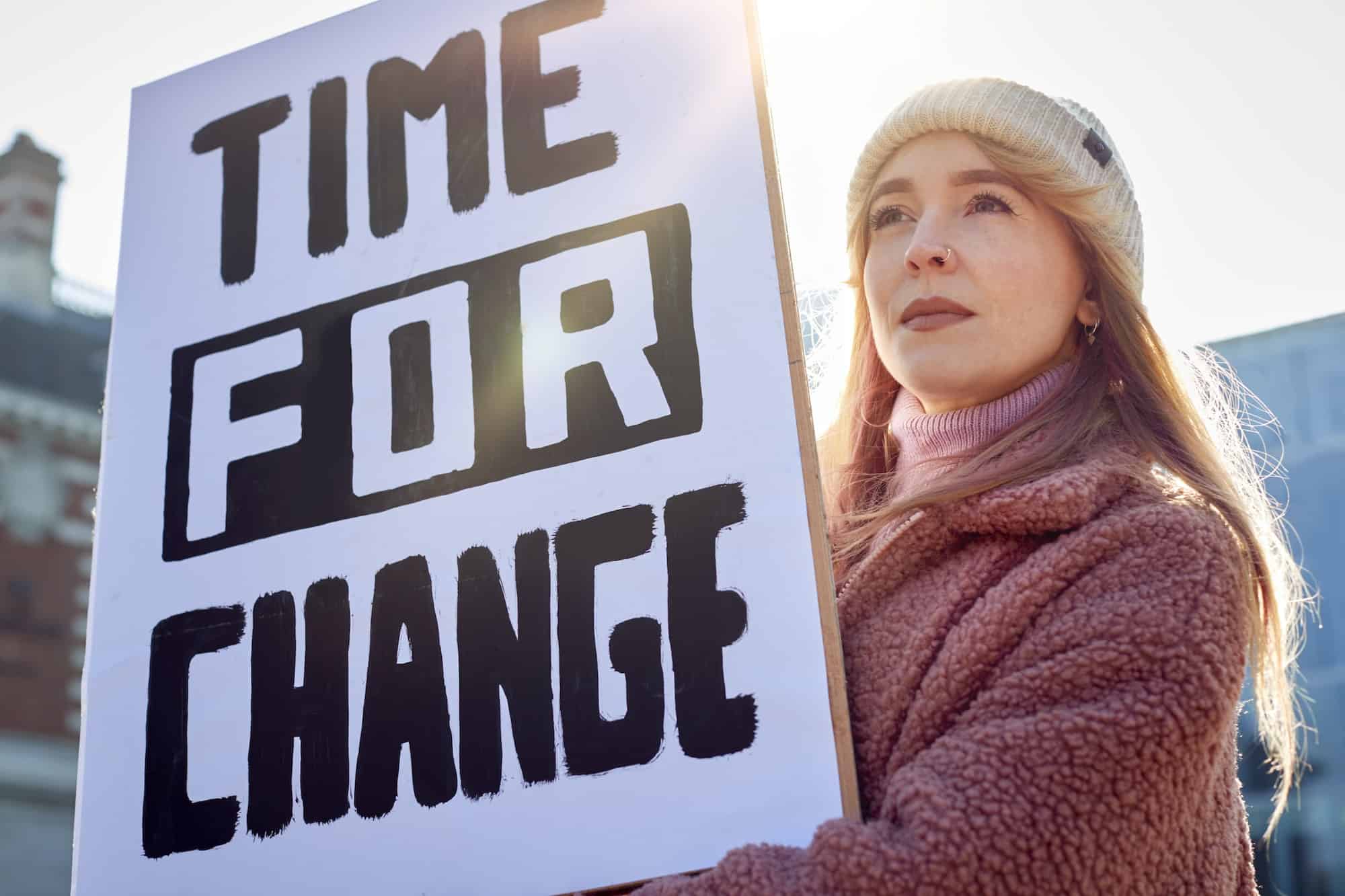 woman holding change sign