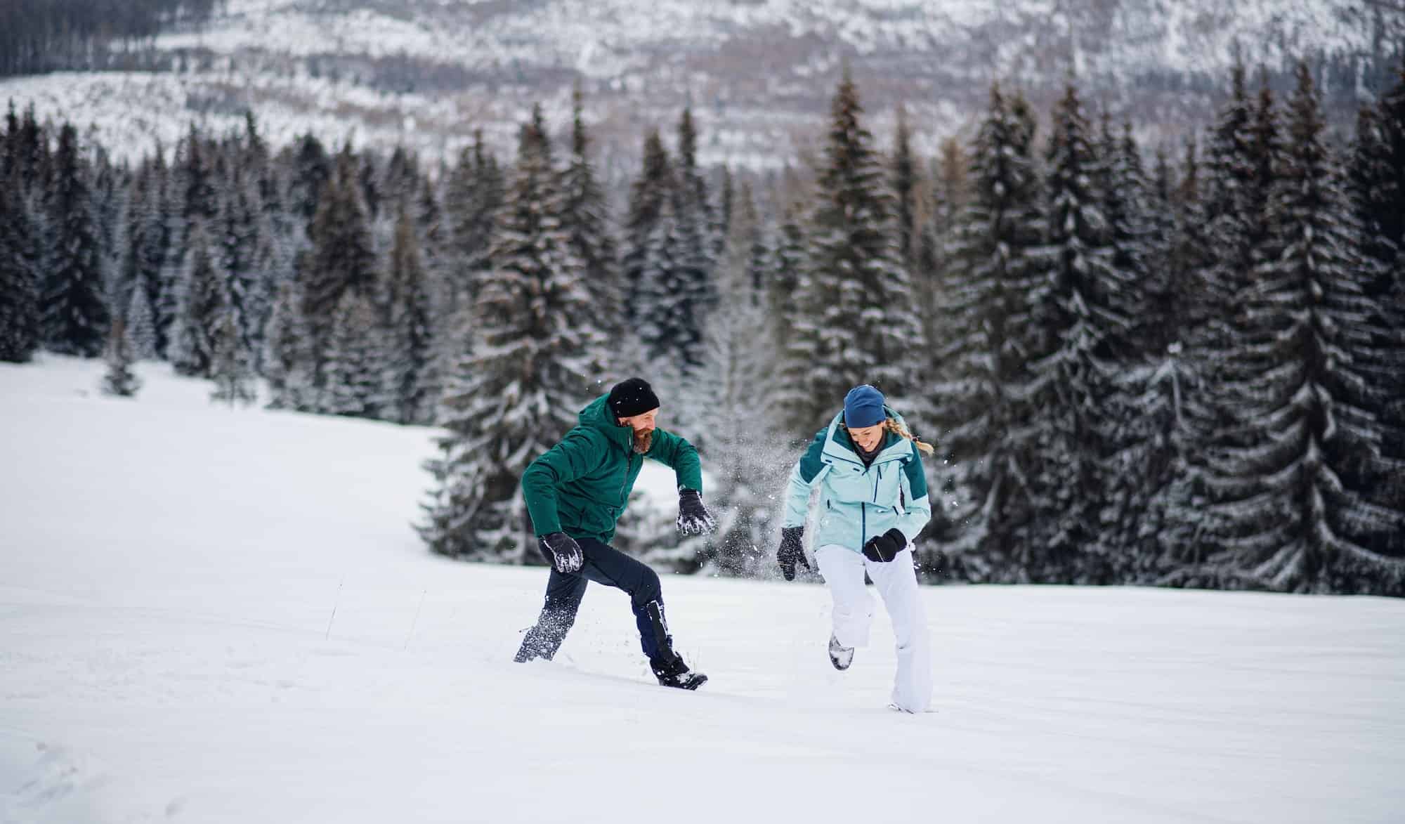 couple running in snow couple running in snow