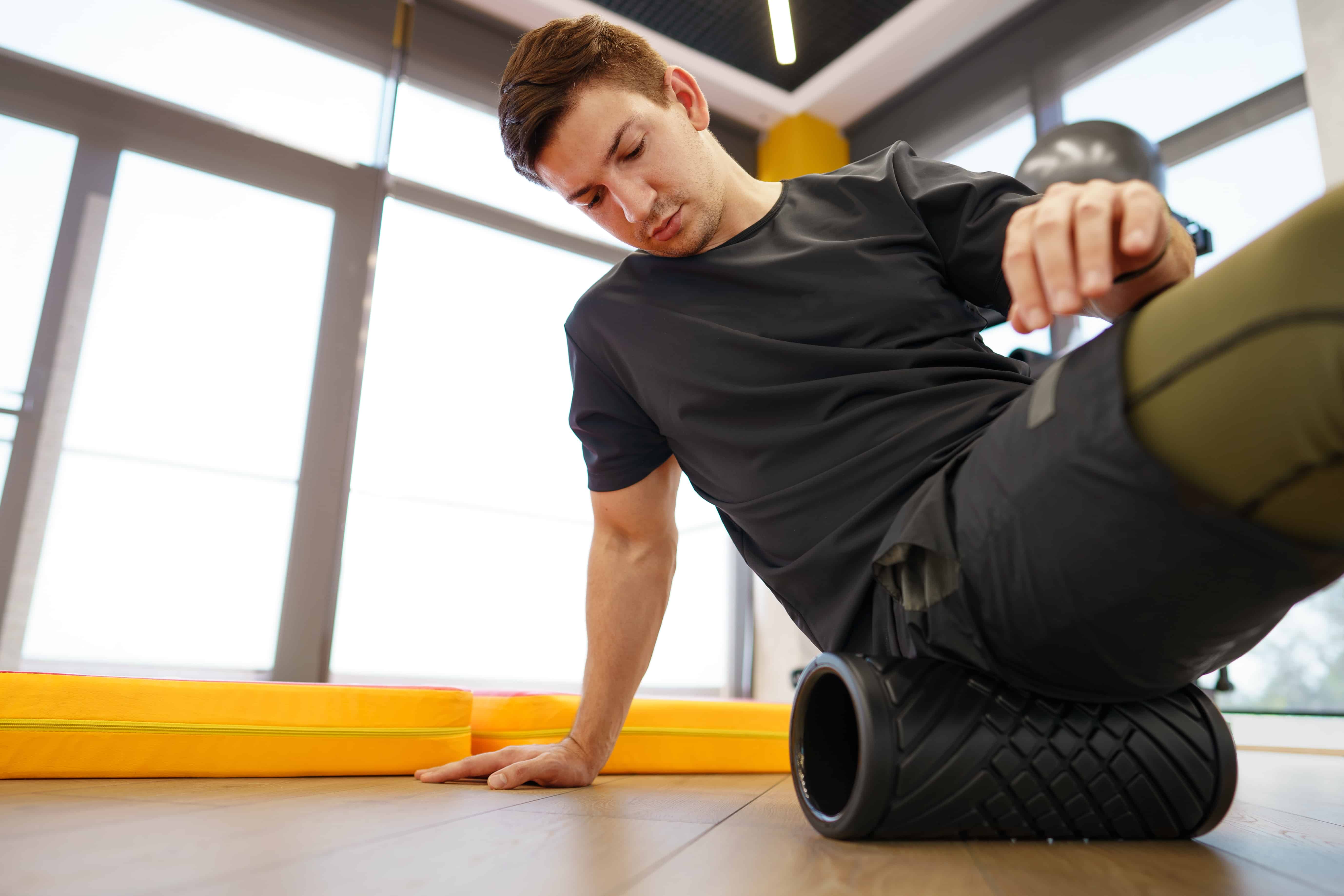 man with foam roller