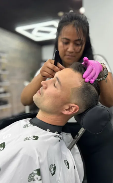 Barber giving a signature precision cut