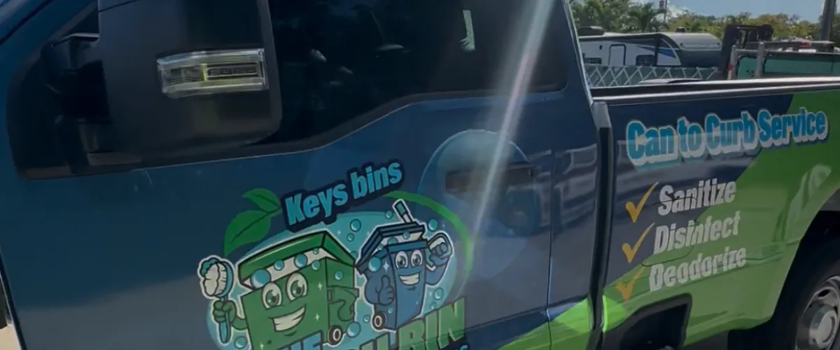 Trash bin cleaning service truck with branding and sanitation features