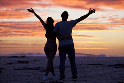Silhouetted couple, sunset in the background. Silhouetted couple, sunset in the background.