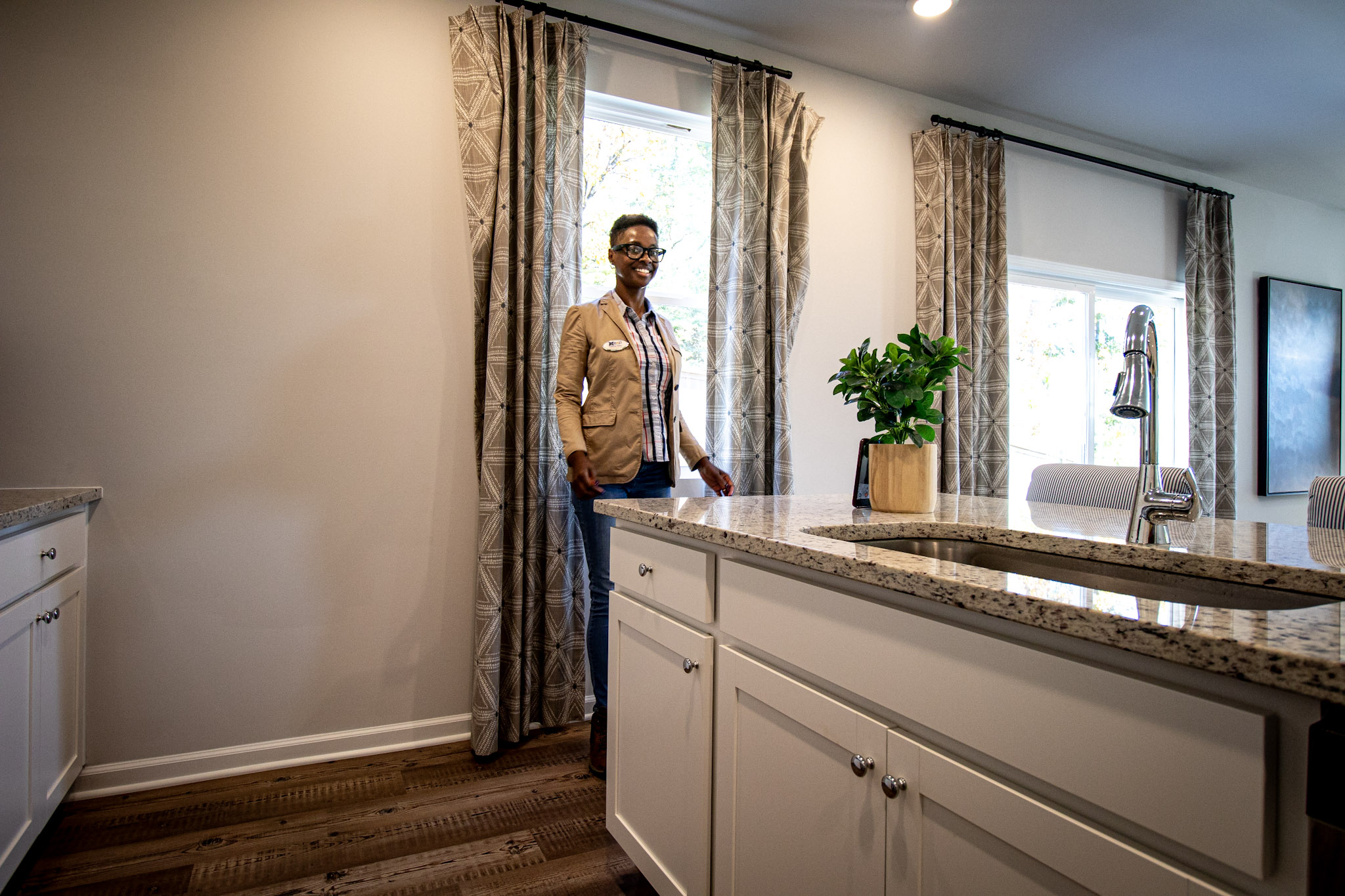 Falecia smiling outside a new home