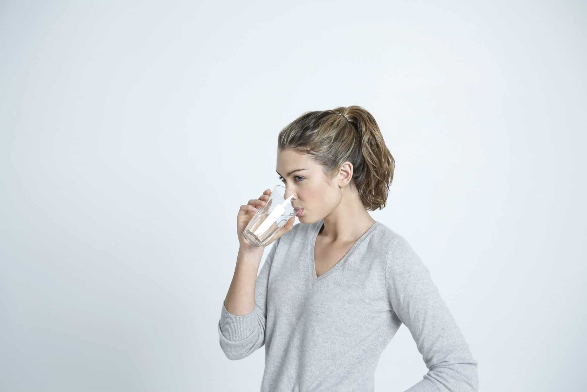 woman drinking a glass of water