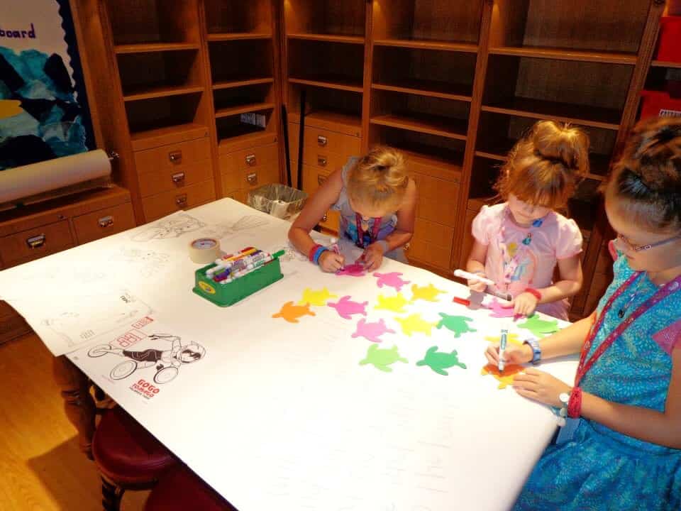 three girls writing on turtle-shaped papers