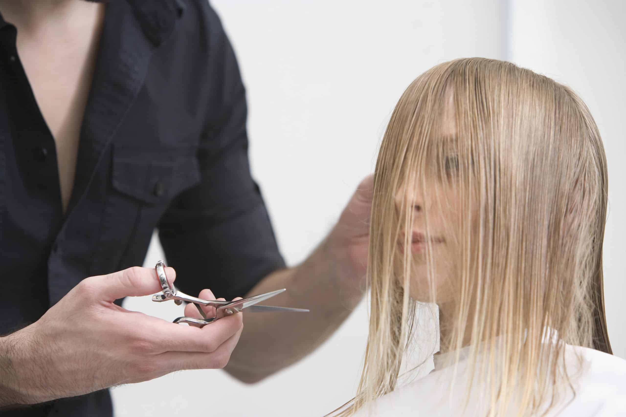 woman about to get bangs cut