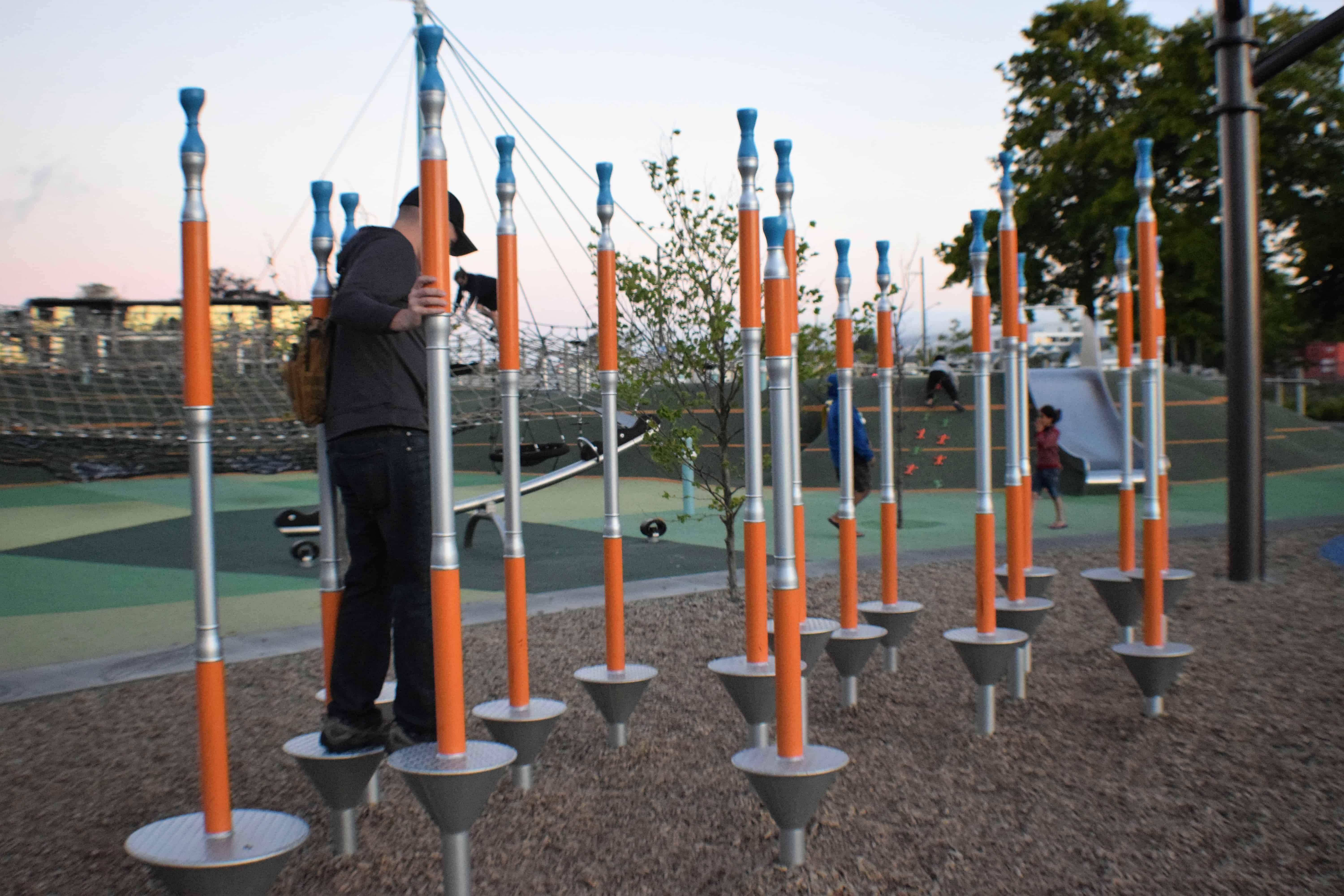 Man navigating adult-sized playground equipment