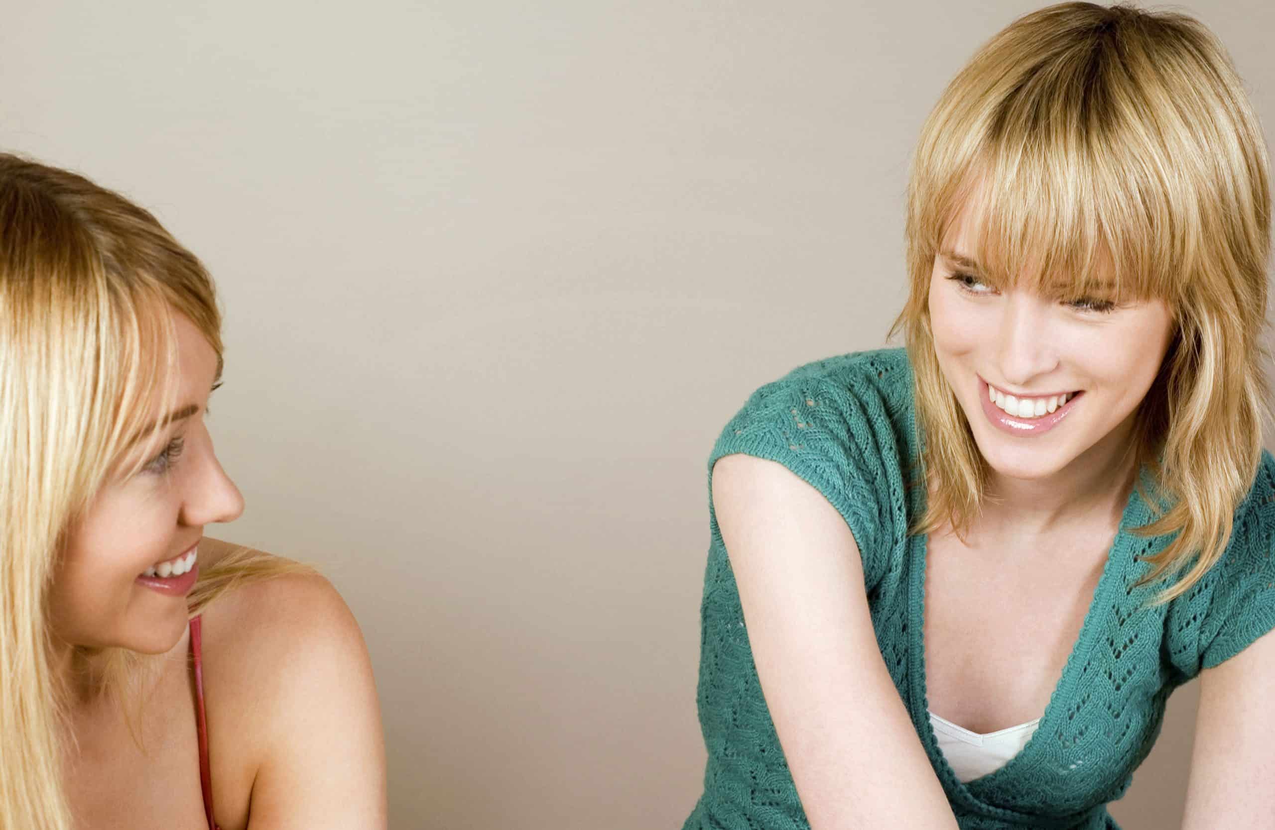 two women laughing together 