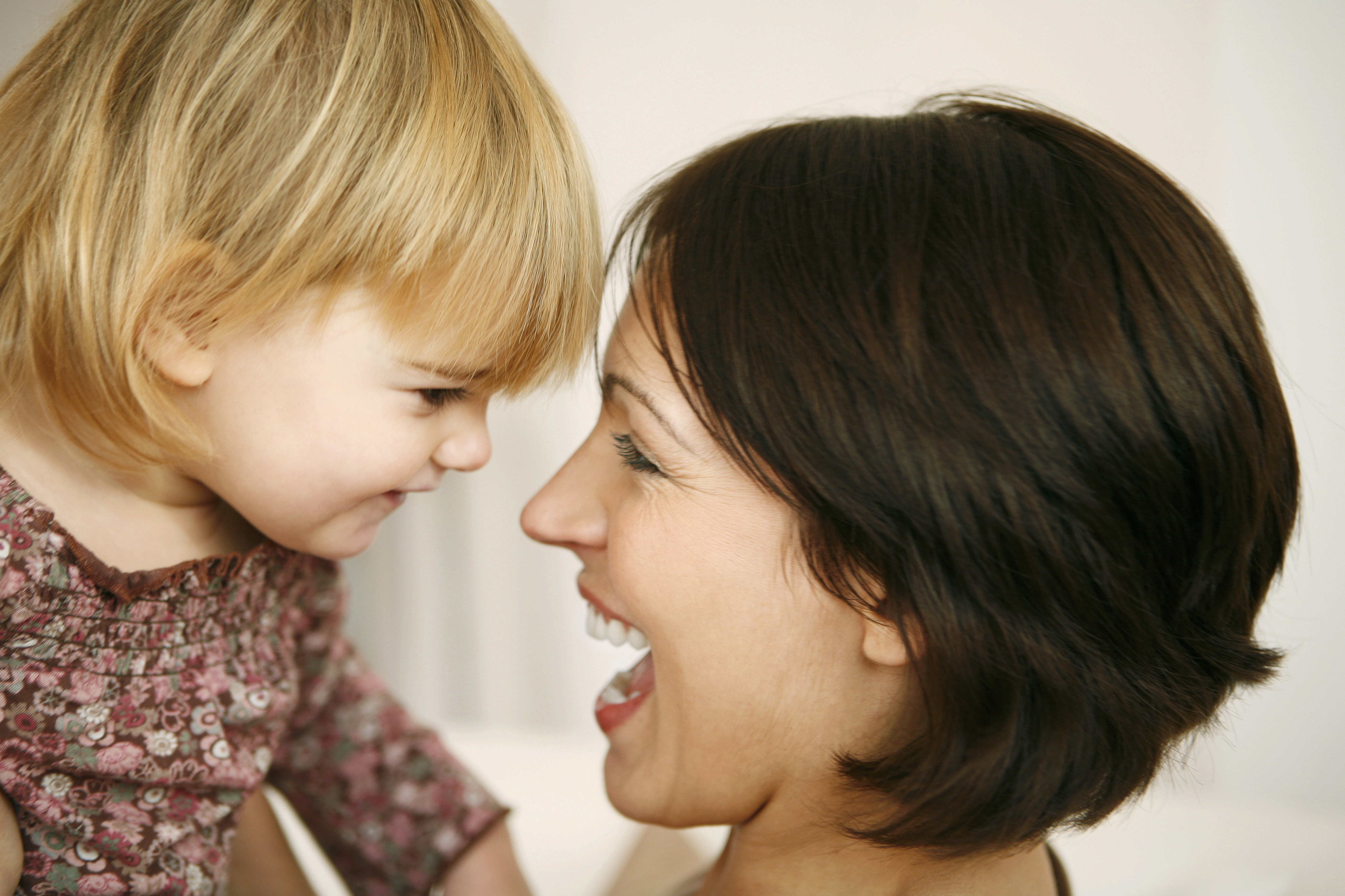 mom laughing with toddler