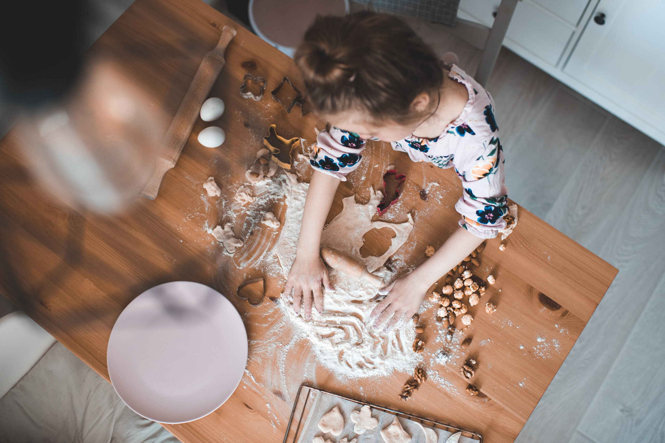 young woman running fingers through flour on a countertop