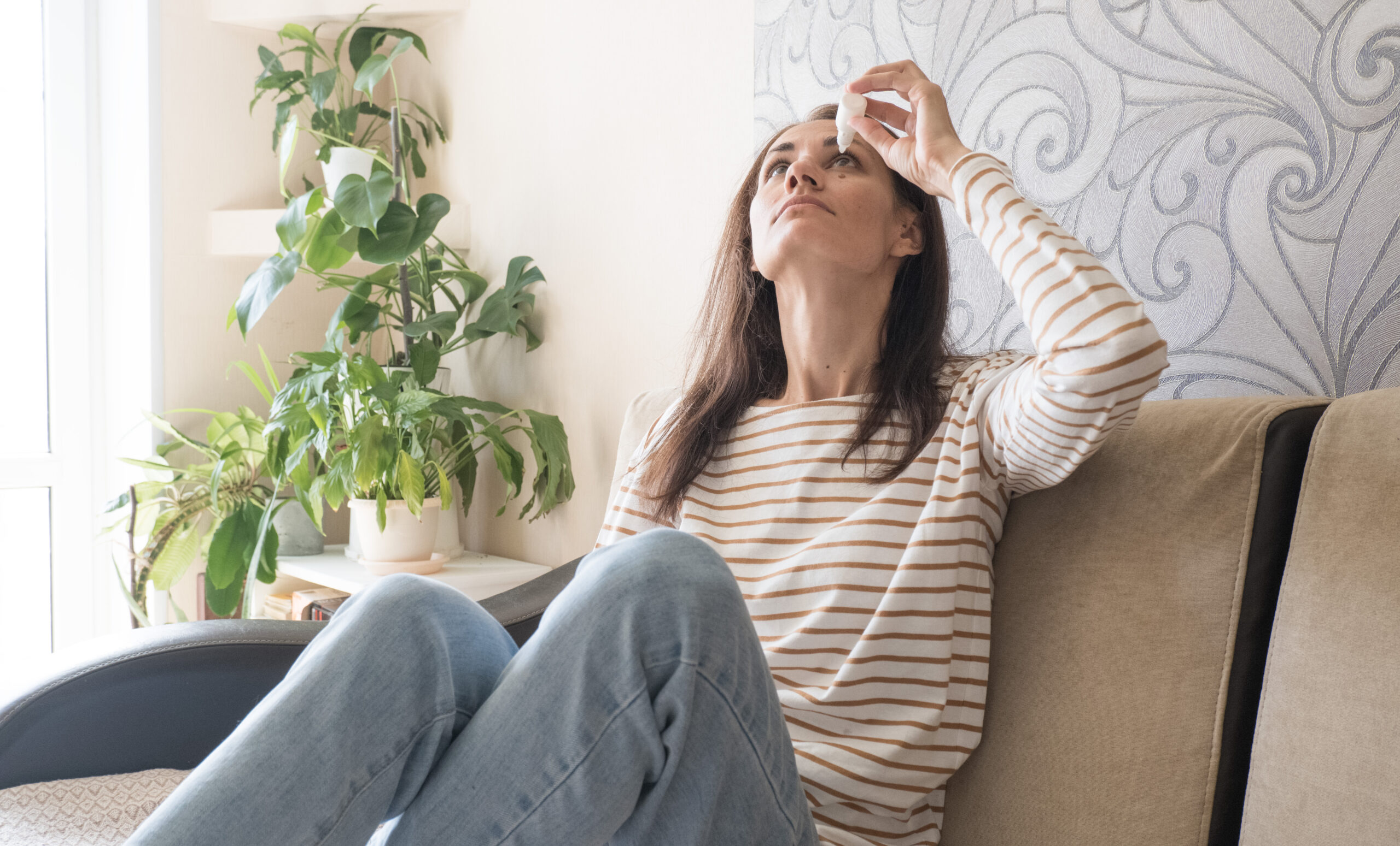 woman using eyes drops