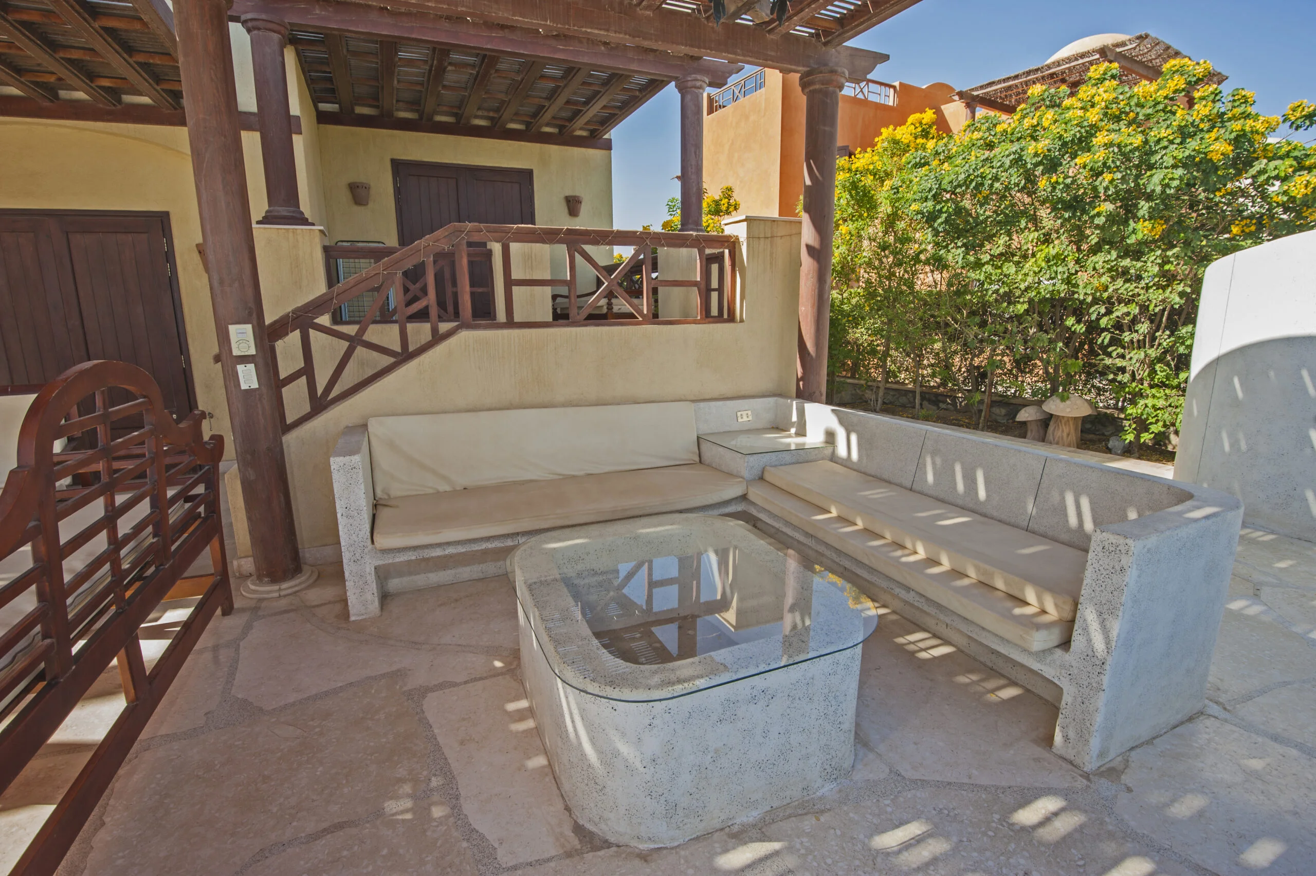 patio area showing sofa and glass table