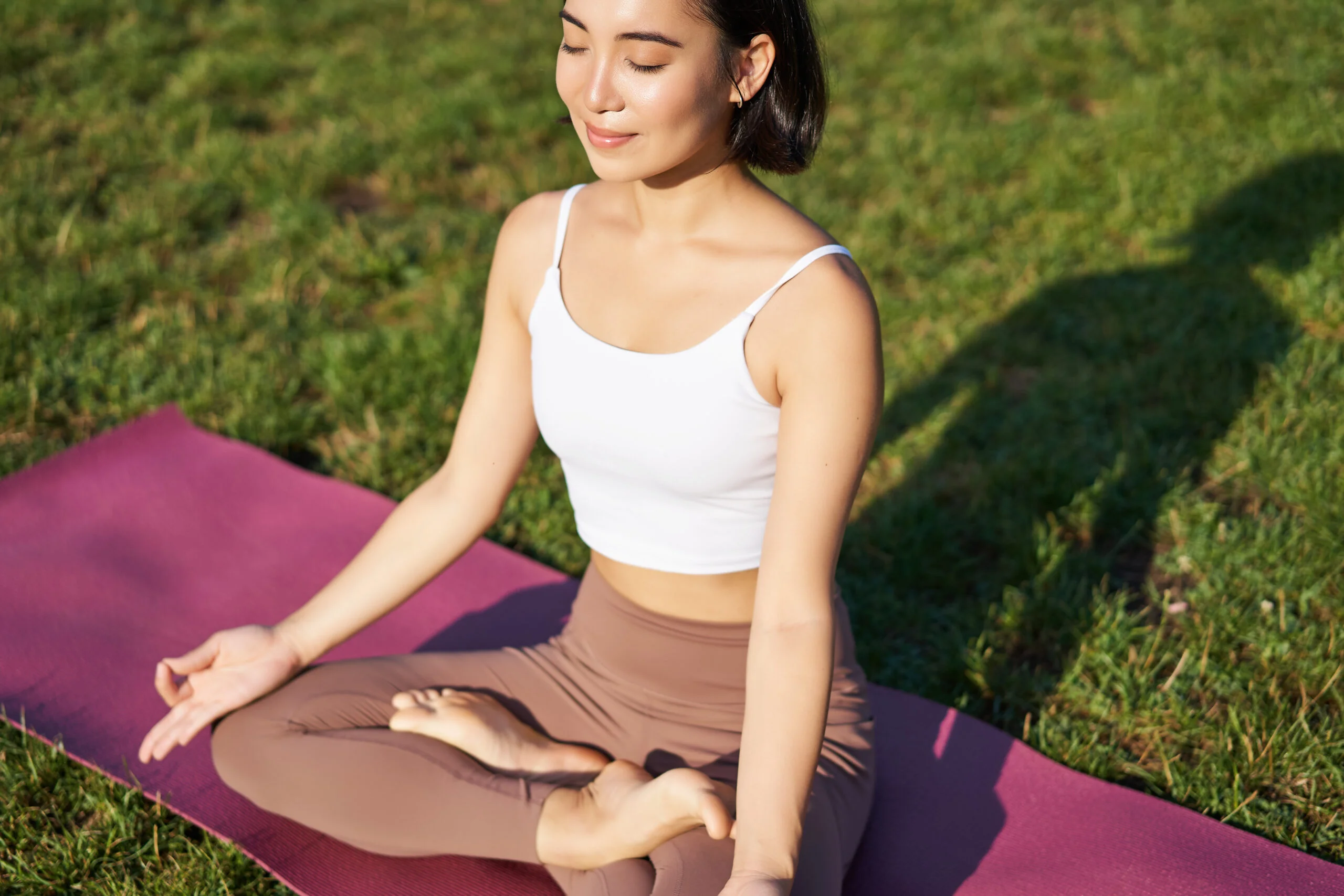 Portrait of smiling asian woman meditating