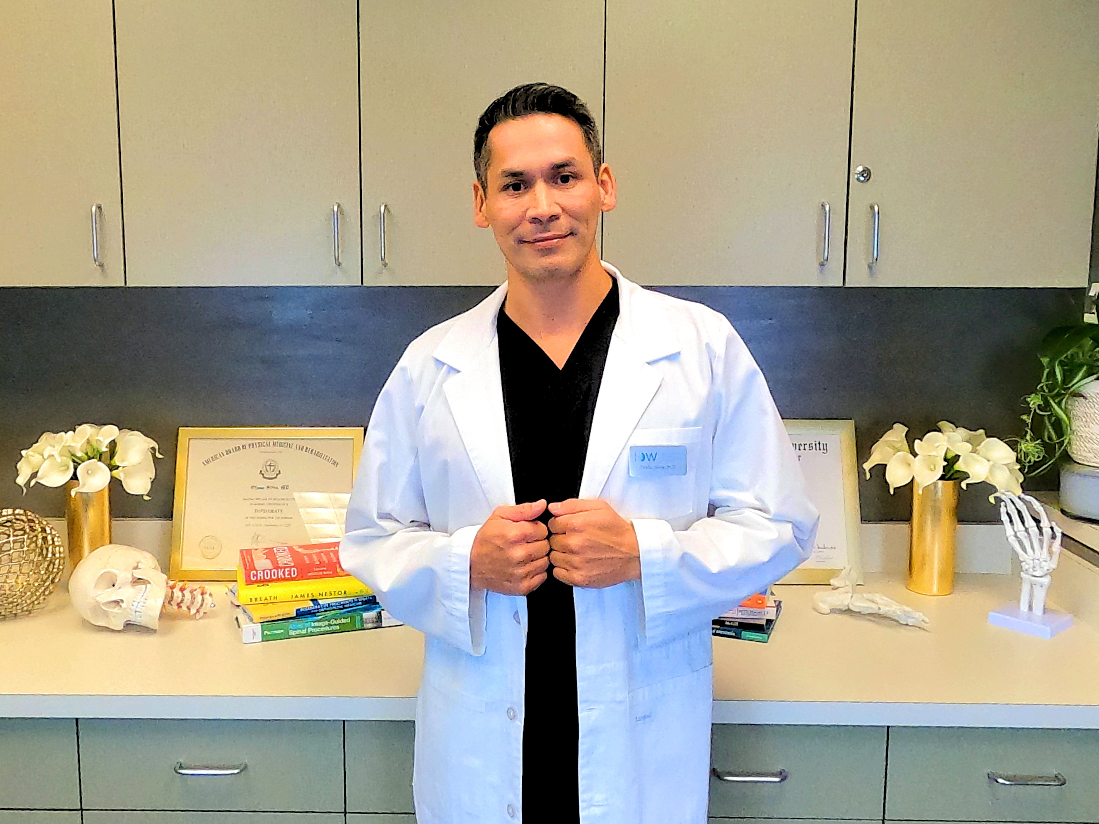 Dr silva smiling in a lab coat