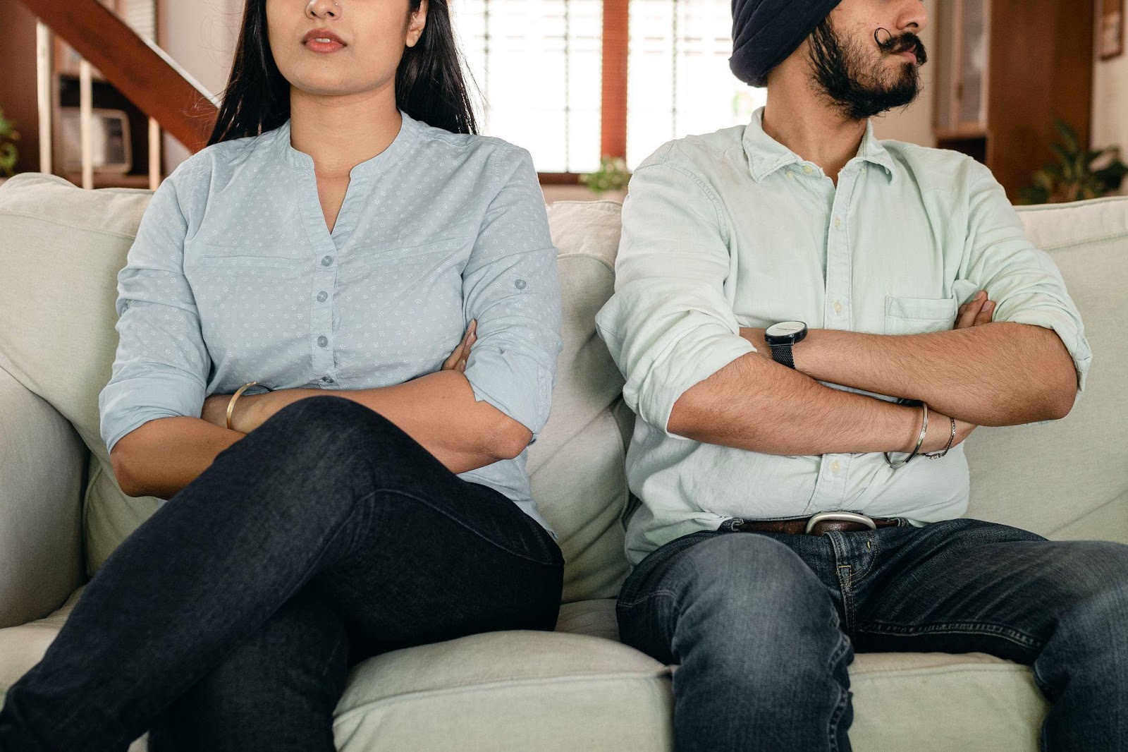 an unhappy couple sitting next to each other