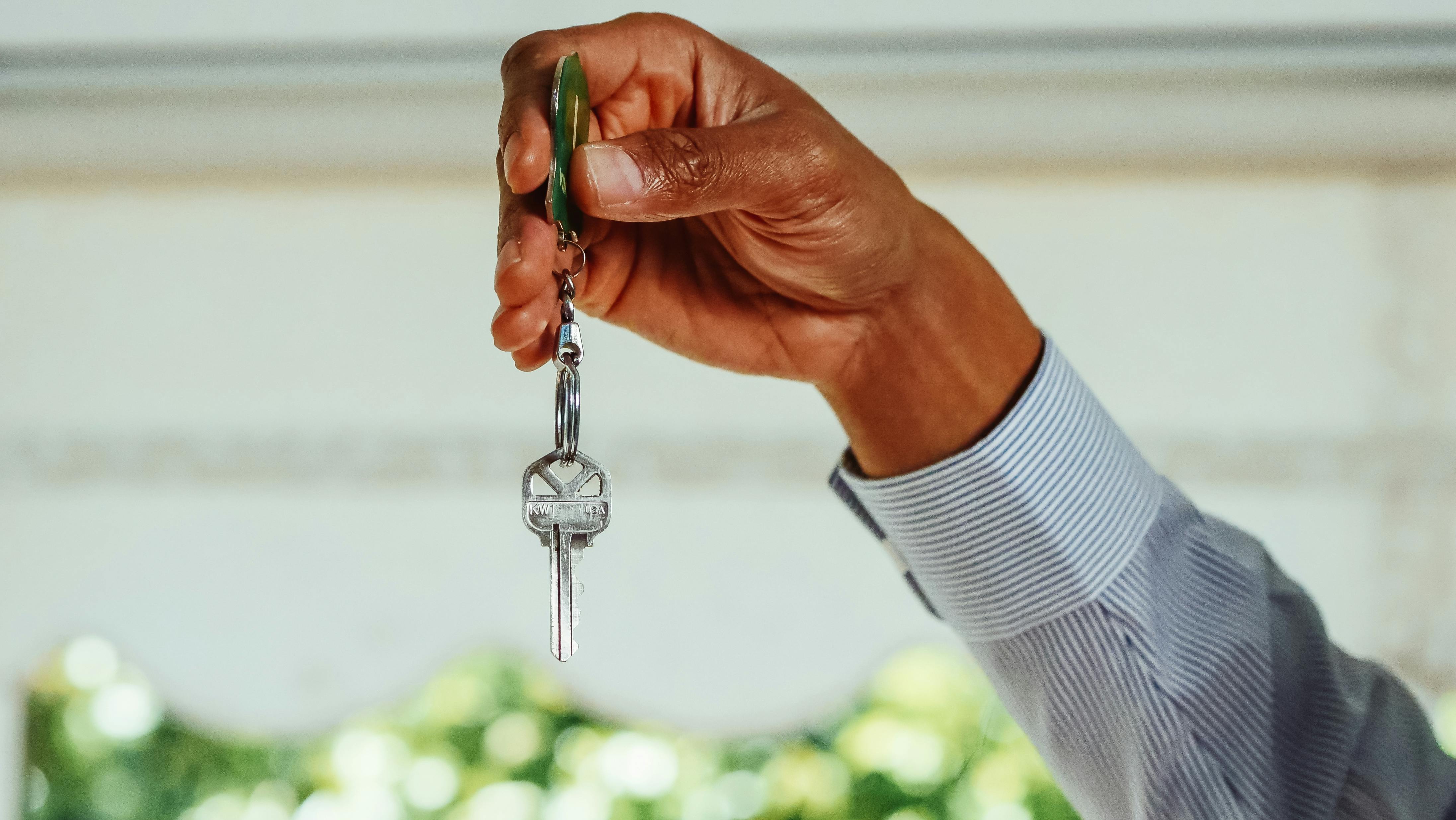 holding a house key holding a house key
