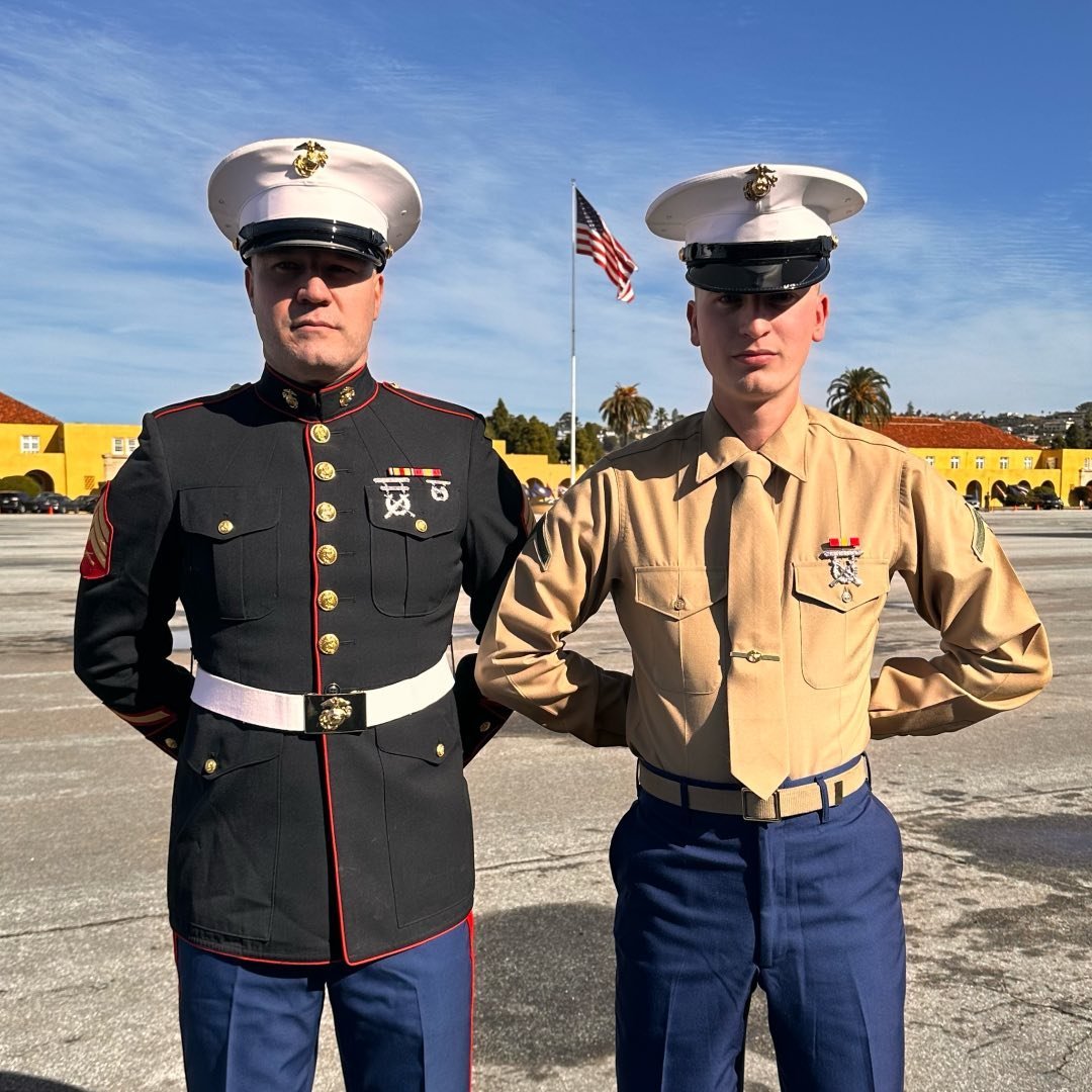 father and son Marines standing next to one another. father and son Marines standing next to one another.