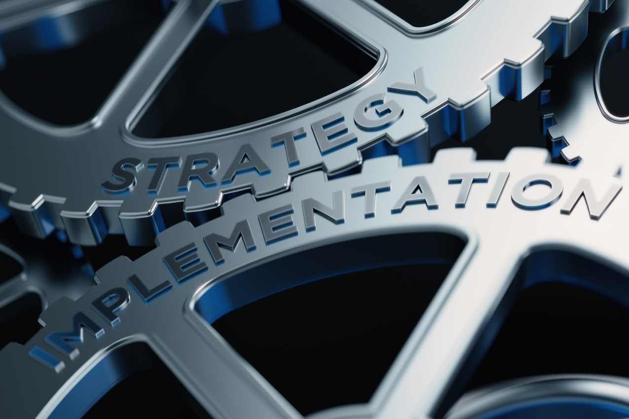 Metal Cogs With Strategy And Implementation Text - Strategy Conceptc