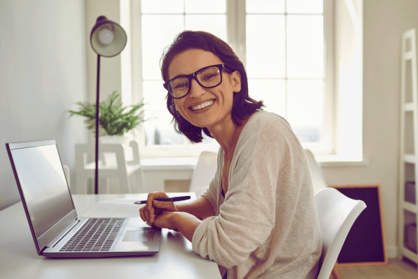 Women looking very happy in front of her laptop. Represents a happy client as their tech works so well for them Women looking very happy in front of her laptop. Represents a happy client as their tech works so well for them