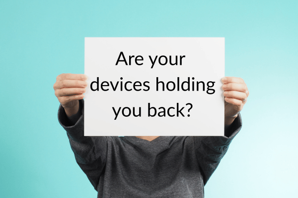 Person holding sign that says "Are old devices holding you back?" Person holding sign that says "Are old devices holding you back?"