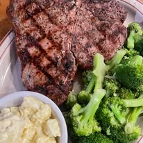 A steak, broccoli, and scalloped potatoes