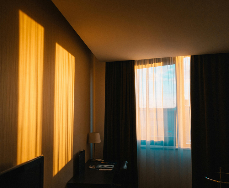 A bedroom with blackout curtains, promoting an optimal sleep environment. A bedroom with blackout curtains, promoting an optimal sleep environment.