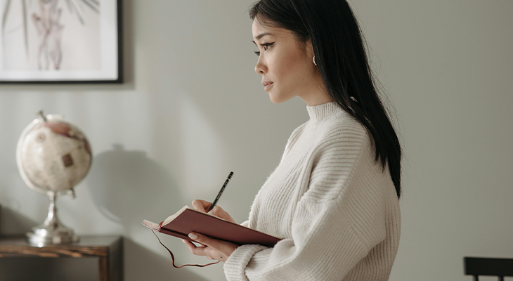 Individual holding a gratitude journal, emphasizing the importance of gratitude and self-compassion in stress resilience. Individual holding a gratitude journal, emphasizing the importance of gratitude and self-compassion in stress resilience.