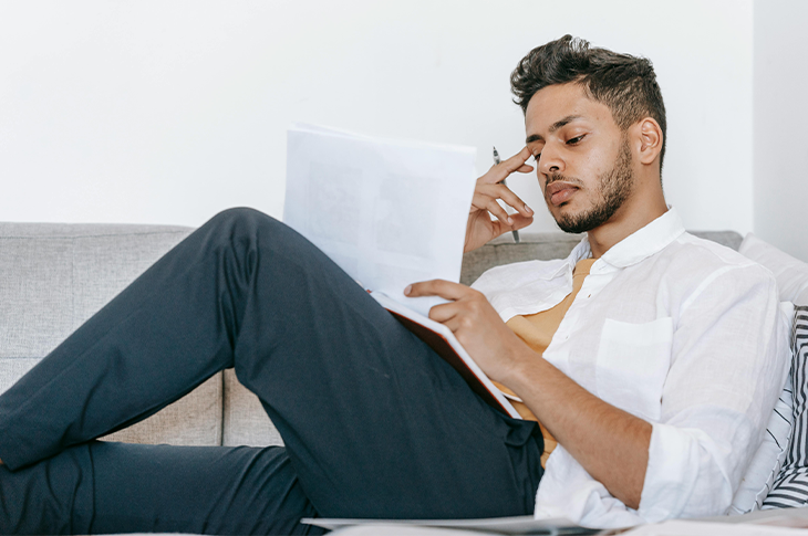 Individual reflecting with a notepad, highlighting the importance of understanding stress and its triggers. Individual reflecting with a notepad, highlighting the importance of understanding stress and its triggers.