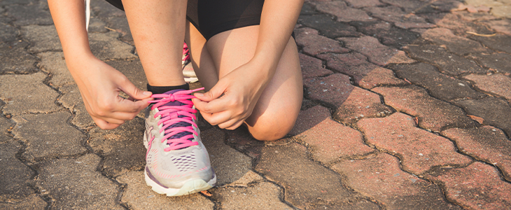 Tying shoes for a jog, demonstrating the stress-reducing benefits of physical activity. Tying shoes for a jog, demonstrating the stress-reducing benefits of physical activity.