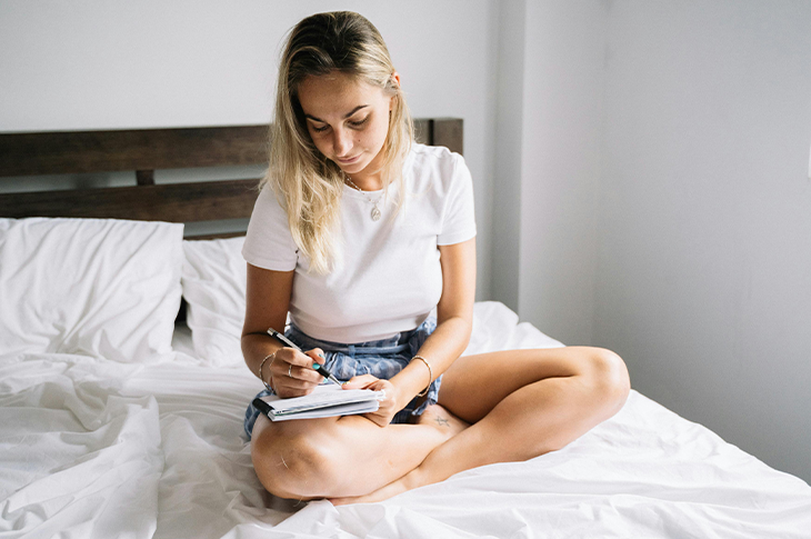 Person journaling to track stress triggers and emotional responses. Person journaling to track stress triggers and emotional responses.