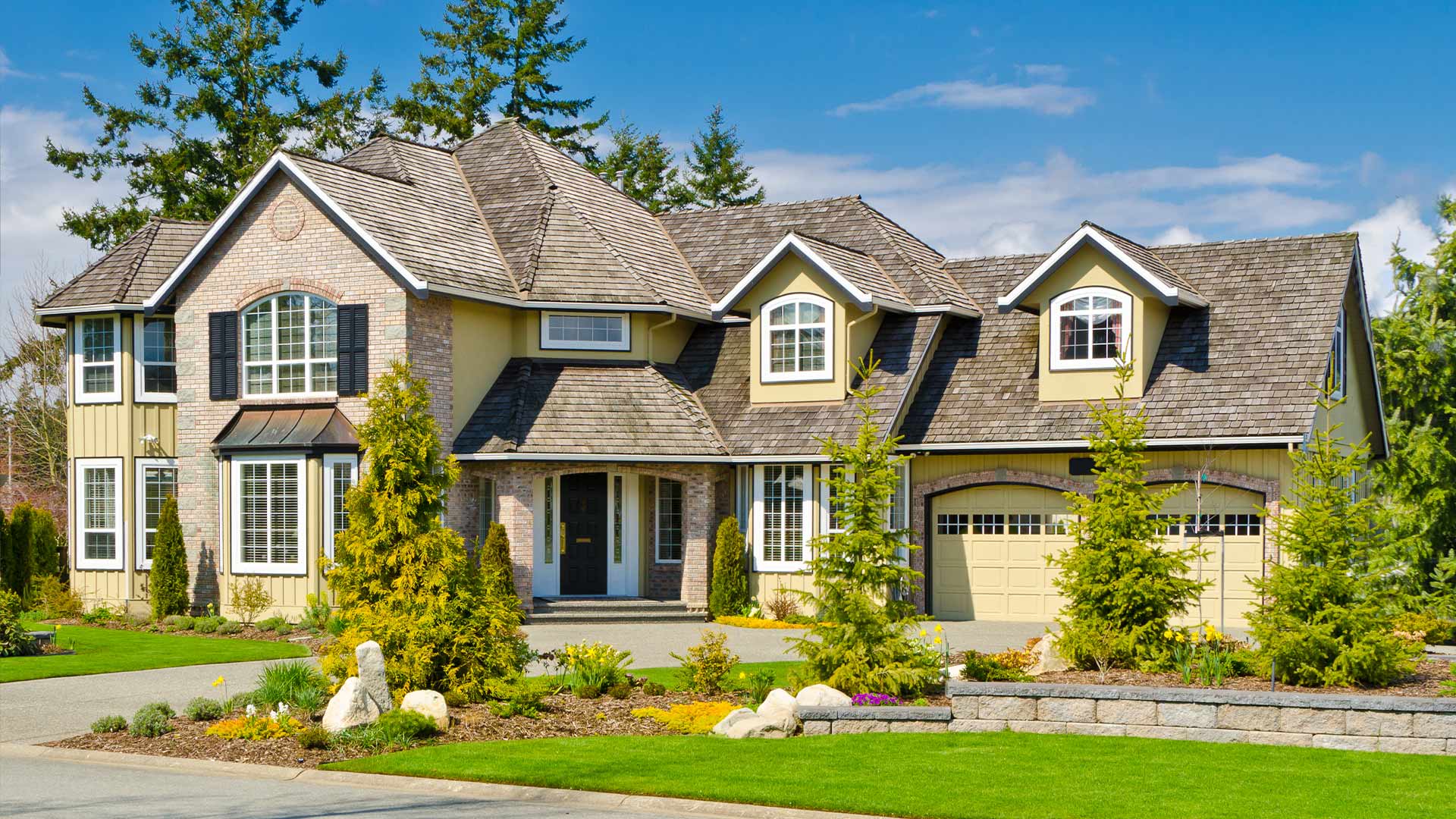 a house with a driveway and trees