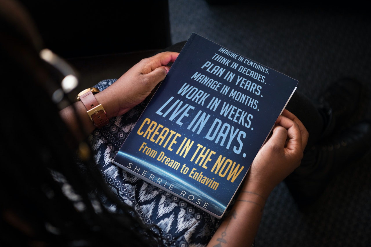 Hands holding a book about time and creation