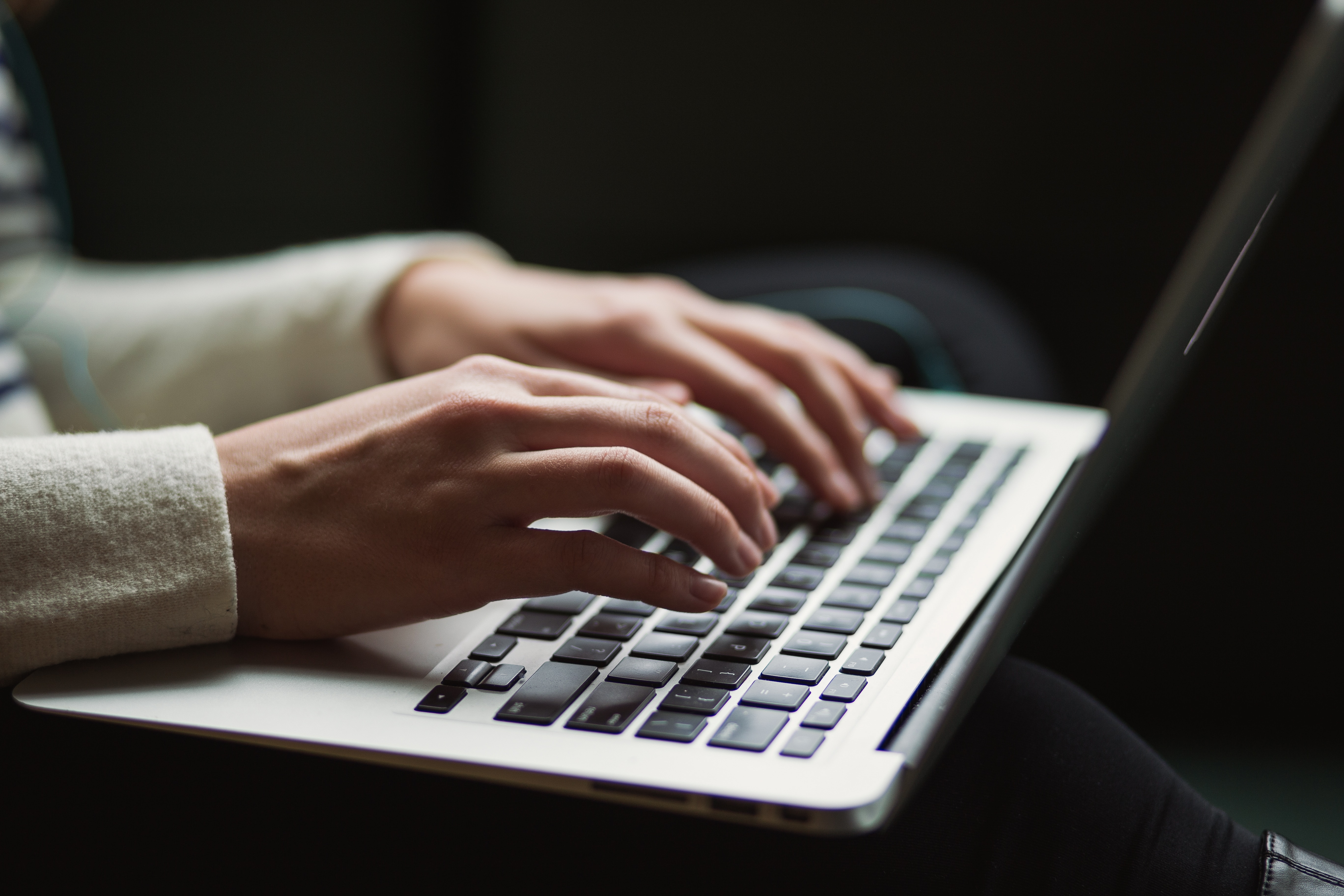 picture of someone typing on a macbook