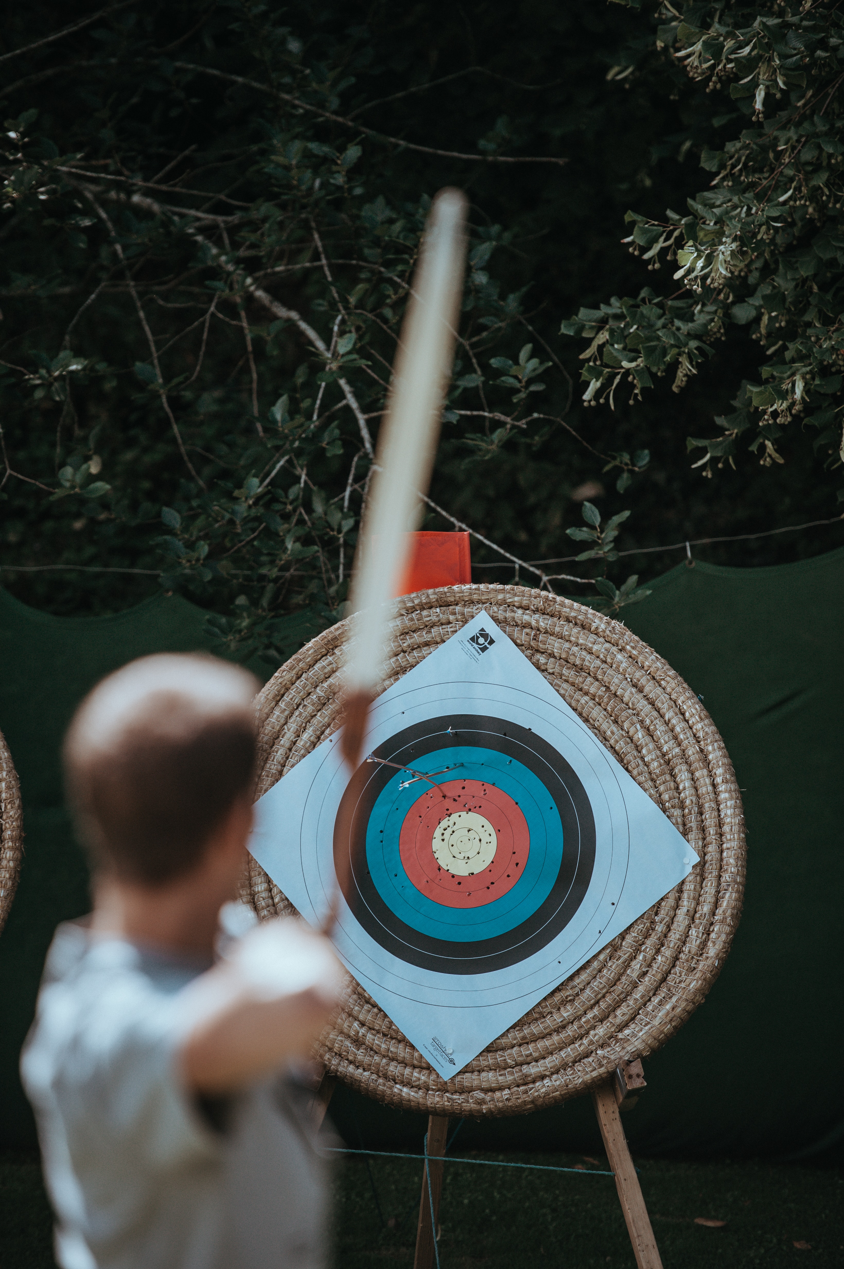 man shooting a bow-an-arrow at a target