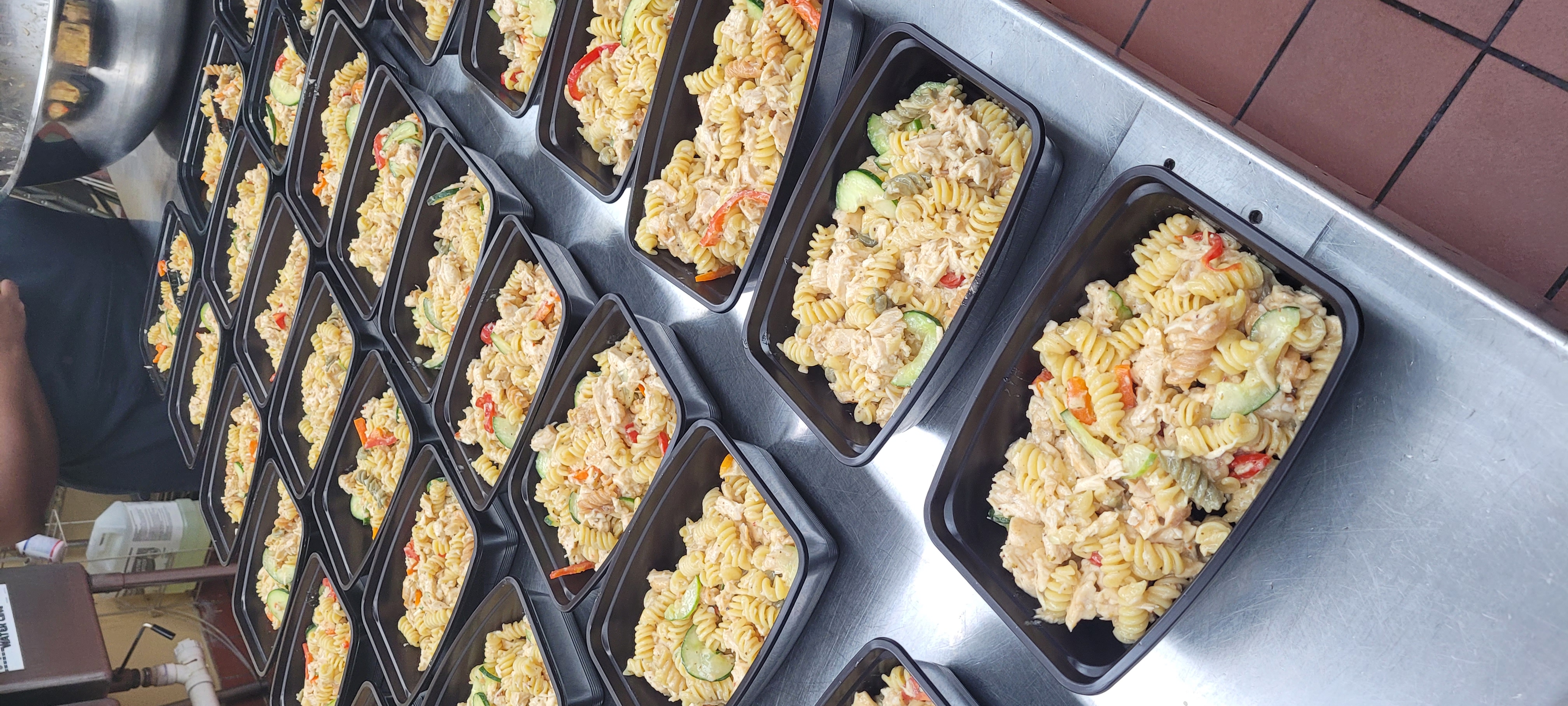 Colorful charcuterie platter with cheeses, crackers, grapes, strawberries, olives, salami, and a bowl of pimento dip