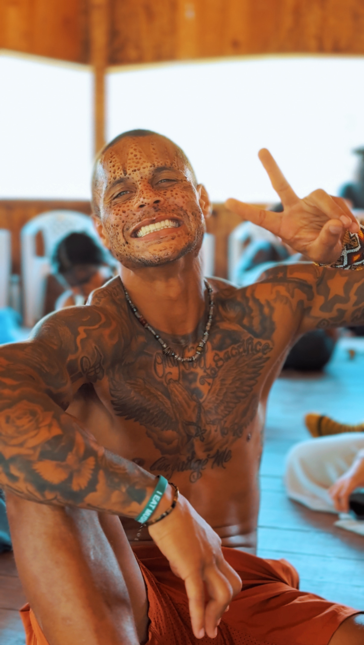 A man with facepainting, smiling.