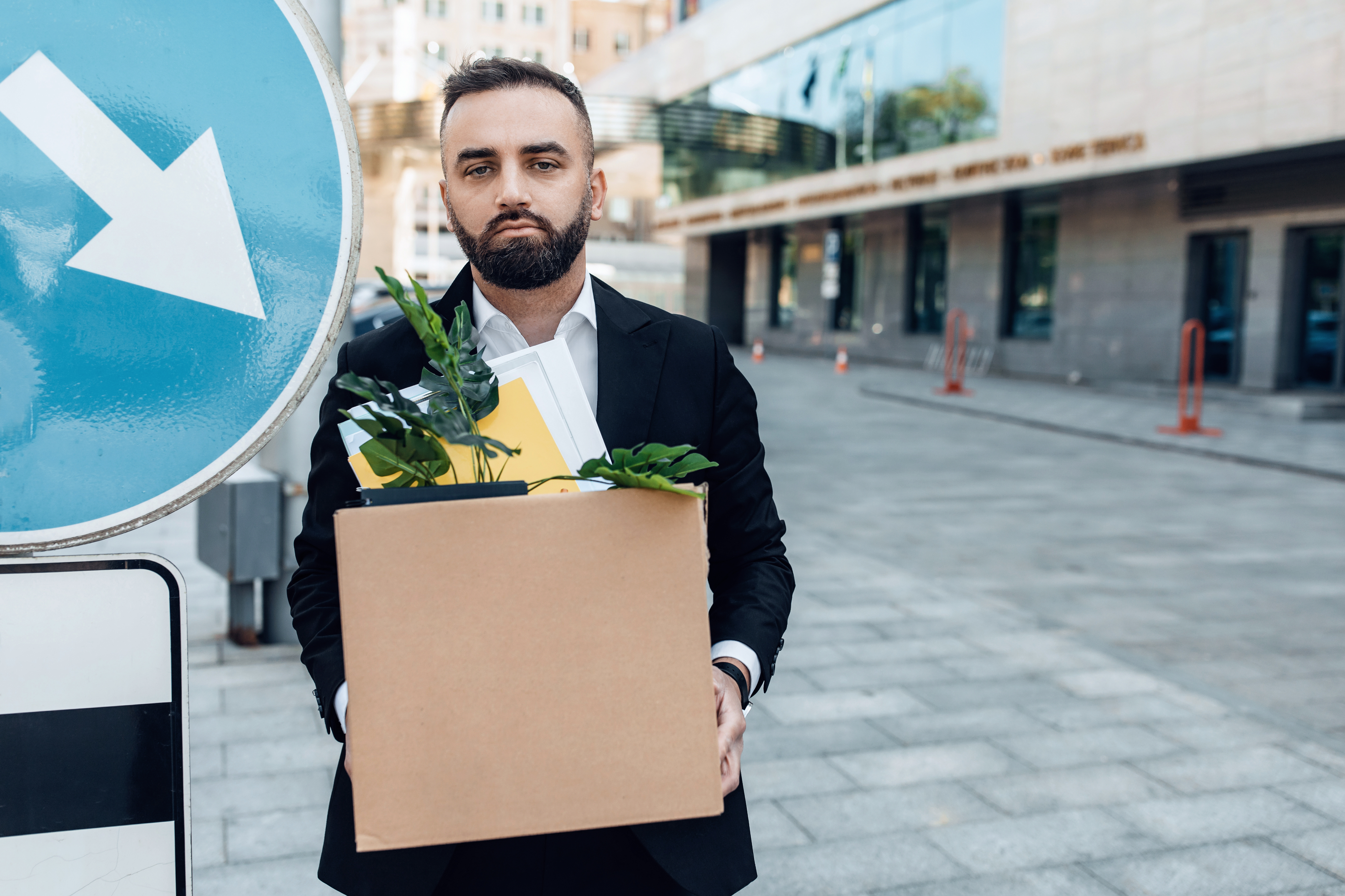 Man with box of office items
