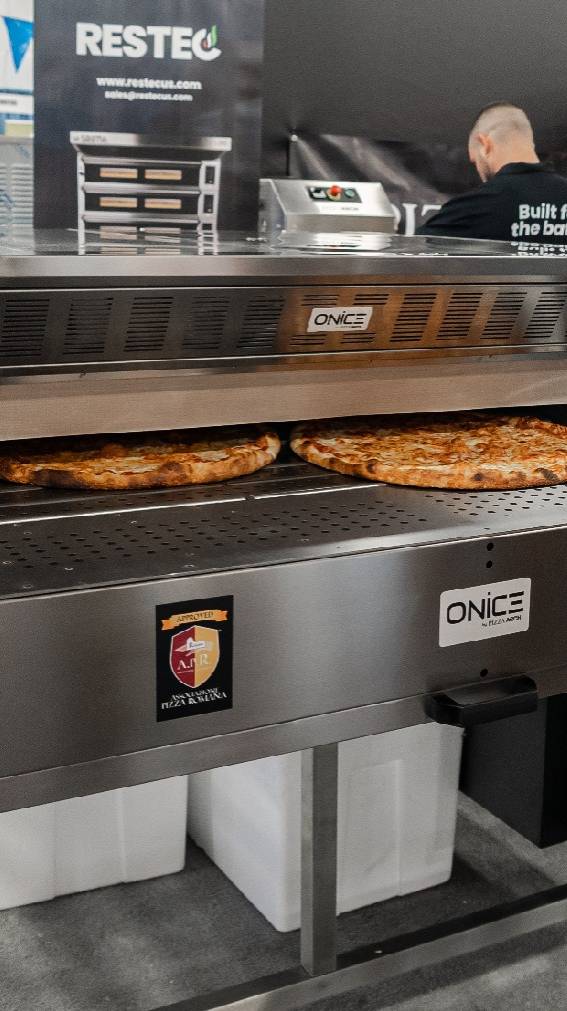 The ONICE oven by PizzaArch features a natural stone conveyor baking tunnel for consistent, stone-baked pizza with high efficiency, speed, and lower energy costs.