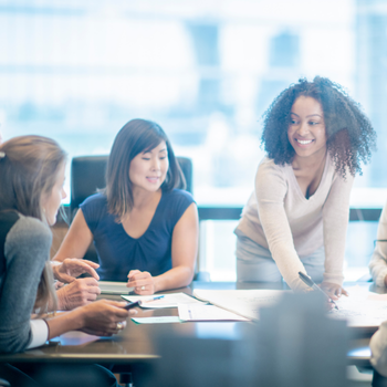 Woman leading team meeting in a dealership, representing leadership and empowerment. Woman leading team meeting in a dealership, representing leadership and empowerment.