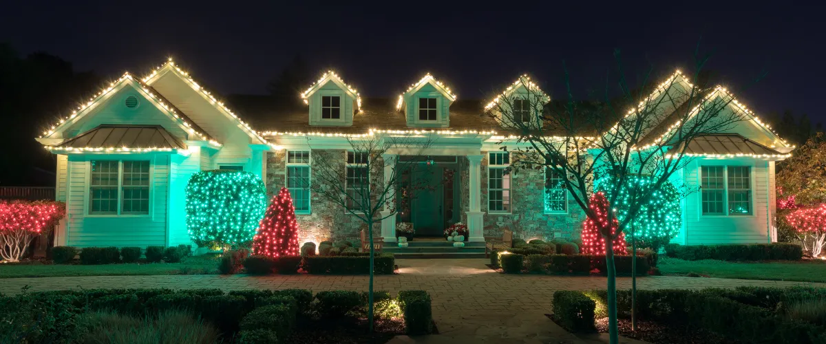 Modern house beautifully decorated with white and colored Christmas lights. Modern house beautifully decorated with white and colored Christmas lights.