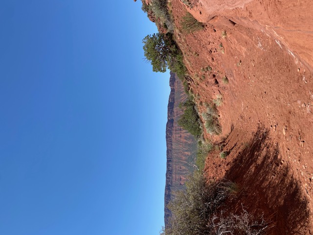 This may very well be from the trail coming out of the canyon,  huge cliffs of rock in the background