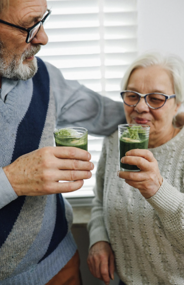 couple drinking green juice couple drinking green juice