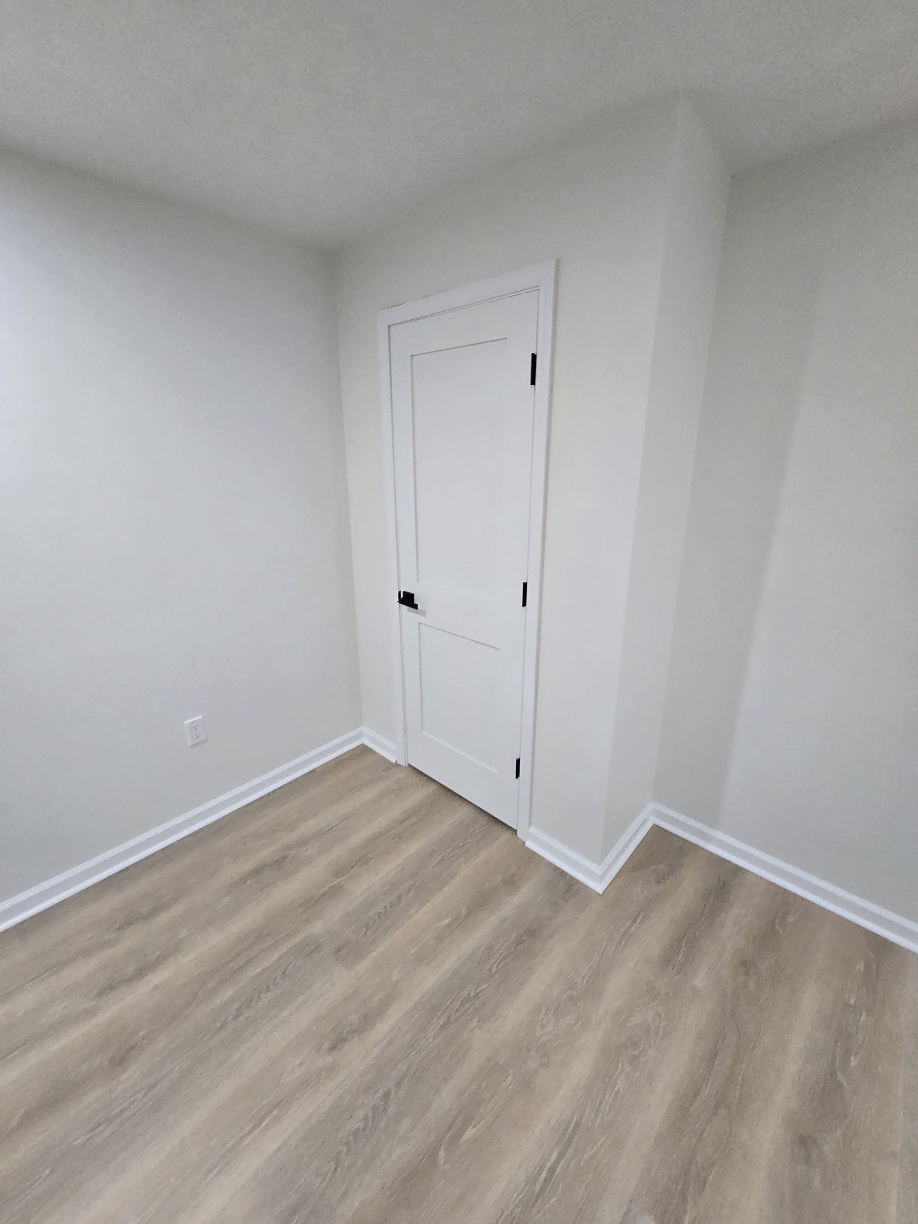 Wood-look flooring detail and clean baseboard transitions