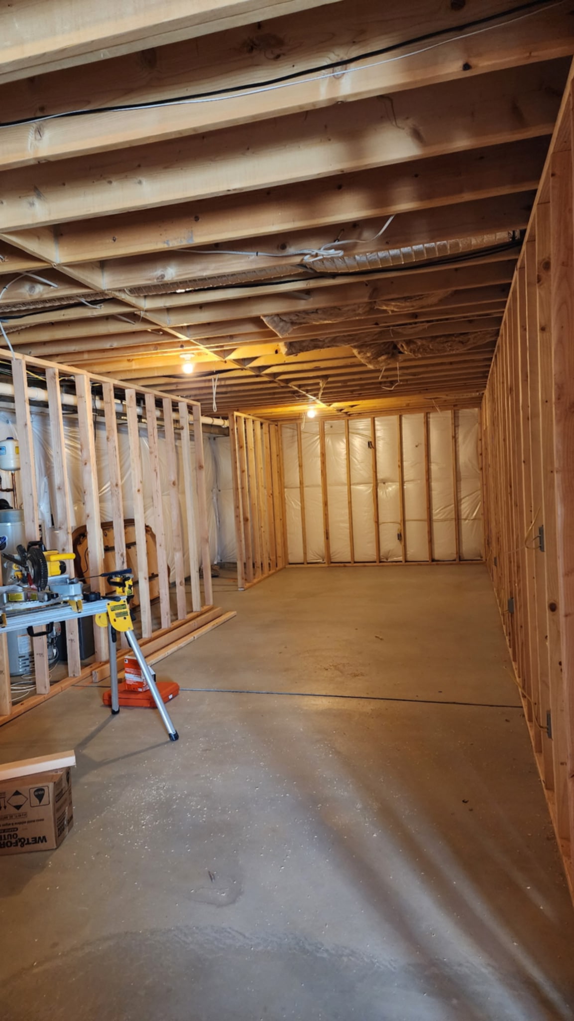 Finished basement: open living area with wood-look floors and recessed lighting