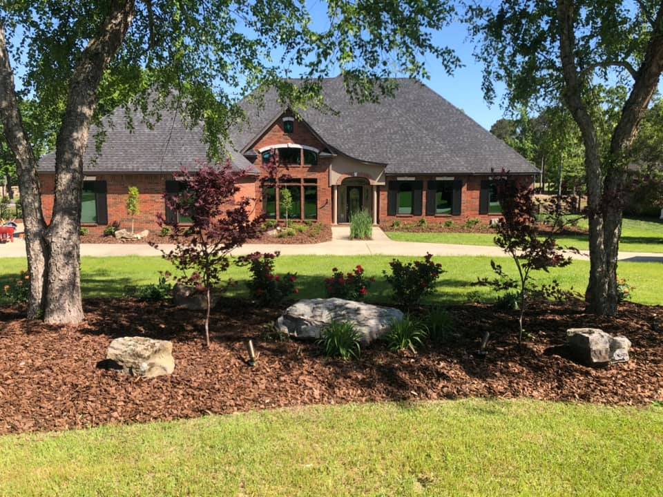 Freshly landscaped yard with flower beds and shrubs in Rayville, LA