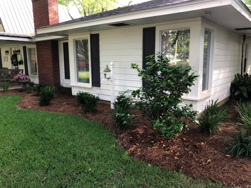 Decorative flower border around a porch in Sterlington, LA