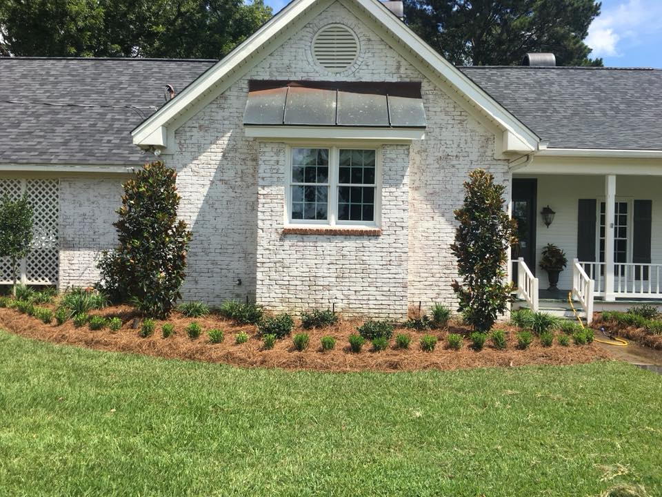 Stone-edged bed with pink roses in Monroe, LA