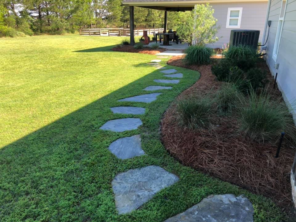 Mulched landscaping with vibrant pink flowers in West Monroe, LA