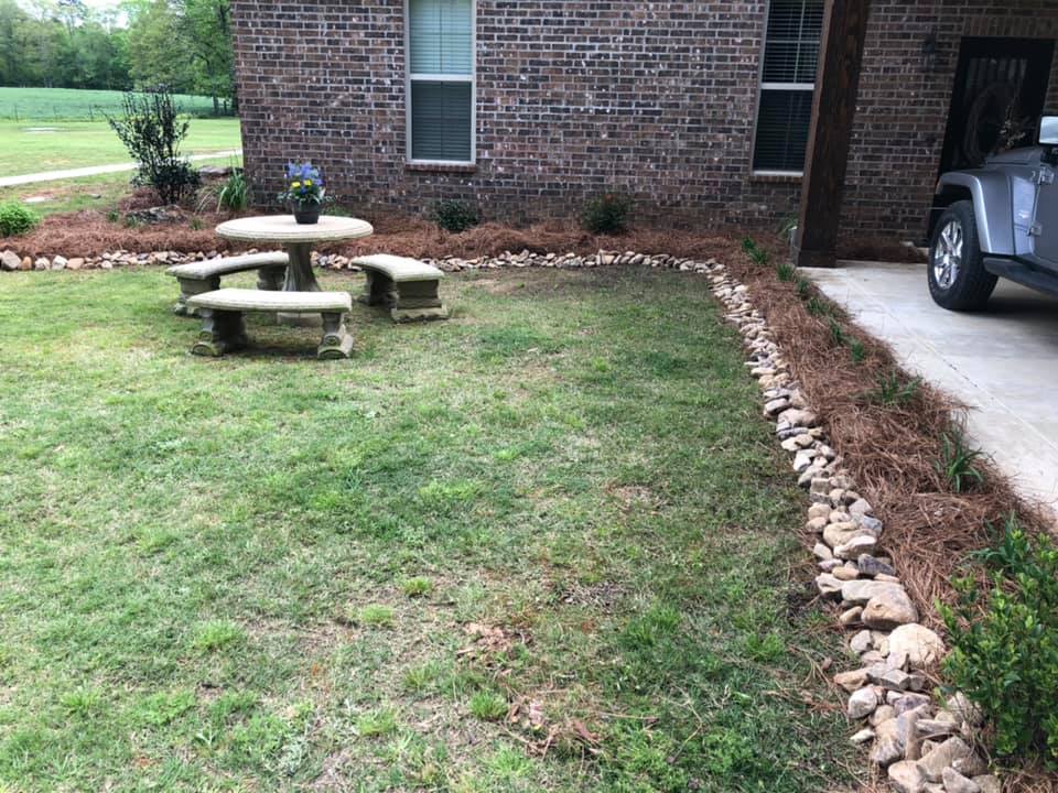 Decorative flower bed surrounding a mailbox in Bastrop, LA