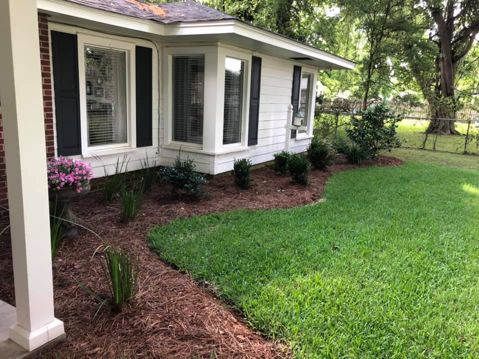 Stone border flower bed with white daisies in West Monroe, LA